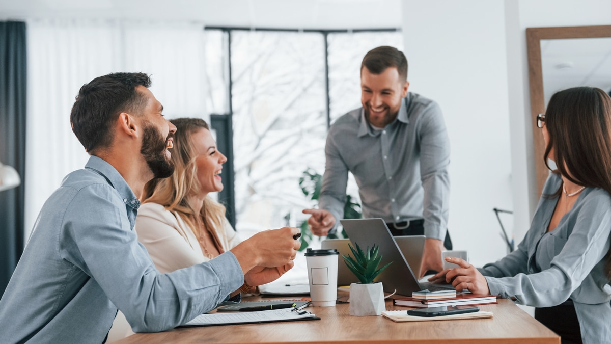 2 men and 2 women sitting at table laughing